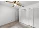 Bedroom features two double-door closets and a ceiling fan for added comfort and storage at 5825 Lake Emma Ct, Groveland, FL 34736