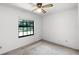 Bedroom with ceiling fan and bright window provides natural light and comfort at 5825 Lake Emma Ct, Groveland, FL 34736