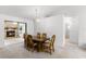 Dining room showcasing a wood dining table, adjoining fireplace, and views to a sun-filled living space at 5825 Lake Emma Ct, Groveland, FL 34736