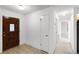 Inviting entryway with tile flooring, neutral walls, and a traditional wood front door at 5825 Lake Emma Ct, Groveland, FL 34736