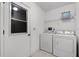 Functional laundry room with washer, dryer, and ample storage space at 5825 Lake Emma Ct, Groveland, FL 34736