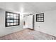 White living room featuring black framed windows and an open door, creating a bright and welcoming atmosphere at 5825 Lake Emma Ct, Groveland, FL 34736