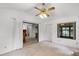 Bright living room with ceiling fan, sliding glass door, and window offers lots of natural light at 5825 Lake Emma Ct, Groveland, FL 34736