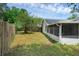 The backyard with wooden fence and view of screened patio at 6556 Piccadilly Ln, Orlando, FL 32835