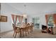 Elegant dining room featuring a chandelier, a wooden table with six chairs, and sliding glass doors at 6556 Piccadilly Ln, Orlando, FL 32835