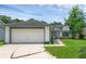 Charming single-story home with a two-car garage, well-maintained lawn, and inviting front entrance at 6556 Piccadilly Ln, Orlando, FL 32835