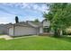 Front elevation of a home with attached garage and well-manicured lawn at 6556 Piccadilly Ln, Orlando, FL 32835