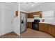 Bright kitchen with a stainless steel refrigerator, black oven, and white countertop space for food prep at 6556 Piccadilly Ln, Orlando, FL 32835