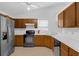 Well-lit kitchen with stainless steel appliances, light countertops, and plenty of cabinet space at 6556 Piccadilly Ln, Orlando, FL 32835