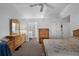 Comfortable main bedroom with a ceiling fan, a dresser, and an ensuite bathroom with a walk-in shower at 6556 Piccadilly Ln, Orlando, FL 32835