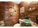 Unique bathroom featuring a barrel sink, ship accents, and wood paneled walls at 672 E Belt Ave, Bushnell, FL 33513