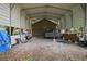 Large carport with ample space for vehicles and storage, featuring a metal frame at 672 E Belt Ave, Bushnell, FL 33513