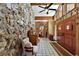 Inviting foyer featuring a stone wall, wood accents, tiled floor, wood door and natural light at 672 E Belt Ave, Bushnell, FL 33513