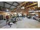 Spacious garage featuring a variety of exercise equipment and ample storage shelving at 672 E Belt Ave, Bushnell, FL 33513