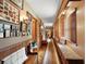 Hallway with wood bench, picture frames on the wall, and wood flooring at 672 E Belt Ave, Bushnell, FL 33513