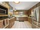 Bright kitchen with modern appliances, ample counter space, and updated cabinetry and tile floors at 672 E Belt Ave, Bushnell, FL 33513