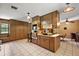 Spacious kitchen with ample cabinetry, modern appliances, an island cooktop, and tiled flooring at 672 E Belt Ave, Bushnell, FL 33513
