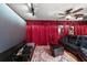 Entertainment room featuring a large screen, projector, comfortable seating, and decorative curtains at 672 E Belt Ave, Bushnell, FL 33513