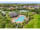 Aerial view showcasing a resort-style pool and tennis courts surrounded by lush landscaping and manicured lawns at 752 Sandy Bar Dr, Winter Garden, FL 34787