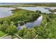 Gorgeous aerial view showcases a pond surrounded by lush greenery and walking path at 752 Sandy Bar Dr, Winter Garden, FL 34787
