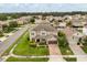 Beautiful aerial view of home showcasing brick driveway, manicured front lawn, and lush landscaping at 752 Sandy Bar Dr, Winter Garden, FL 34787