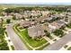 A neighborhood aerial shot showcasing homes with manicured lawns and lush trees and landscaping at 752 Sandy Bar Dr, Winter Garden, FL 34787