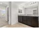 Bathroom featuring a double vanity with dark wood cabinets and tile floors at 752 Sandy Bar Dr, Winter Garden, FL 34787