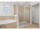 Bathroom featuring a glass-enclosed shower and a soaking tub with tile surround at 752 Sandy Bar Dr, Winter Garden, FL 34787