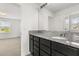 Bathroom with granite countertop, dark cabinets, and a mirror at 752 Sandy Bar Dr, Winter Garden, FL 34787