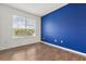 Bedroom showcasing a bright window and a striking blue accent wall at 752 Sandy Bar Dr, Winter Garden, FL 34787