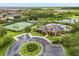 Stunning aerial image showcasing the community clubhouse, tennis courts and a picturesque lake at 752 Sandy Bar Dr, Winter Garden, FL 34787