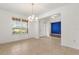 Inviting dining area featuring tiled floors, natural light from the window, and a view of a bright blue accent wall at 752 Sandy Bar Dr, Winter Garden, FL 34787