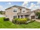 Attractive two-story home with a well-kept lawn and lush green shrubs around the property's foundation at 752 Sandy Bar Dr, Winter Garden, FL 34787