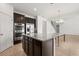Stylish kitchen island with granite countertop and dark wood cabinetry, connecting seamlessly with the dining area at 752 Sandy Bar Dr, Winter Garden, FL 34787