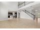 Large open-concept area with tile floors, stairs, and an adjacent kitchen, great for Gathering living at 752 Sandy Bar Dr, Winter Garden, FL 34787