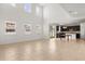 Bright, spacious living room with high ceilings, large windows, and an open view into the modern kitchen at 752 Sandy Bar Dr, Winter Garden, FL 34787