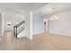 Bright, open living area with neutral tile flooring, a staircase, and views into other rooms at 752 Sandy Bar Dr, Winter Garden, FL 34787