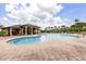 Resort-style swimming pool and clubhouse surrounded by lush landscaping and palm trees for relaxation and enjoyment at 752 Sandy Bar Dr, Winter Garden, FL 34787