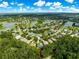 A view of a lakeside community featuring many homes nestled around serene lakes and surrounded by mature trees and green spaces at 8045 Waterbury Way, Mount Dora, FL 32757