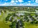 Extensive aerial view of the community showcasing multiple lakes, community pool, clubhouse, and lush landscaping at 8045 Waterbury Way, Mount Dora, FL 32757
