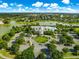 Scenic aerial view of the community clubhouse, pool, and surrounding neighborhood with mature trees and landscaping at 8045 Waterbury Way, Mount Dora, FL 32757