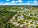 Aerial photograph highlighting a community with lush landscaping, water features, and recreational opportunities at 8045 Waterbury Way, Mount Dora, FL 32757
