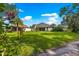 Backyard showcases a well-kept lawn and view of the back of the home at 8045 Waterbury Way, Mount Dora, FL 32757