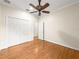 Bedroom featuring hardwood floors, a ceiling fan, and closet at 8045 Waterbury Way, Mount Dora, FL 32757