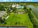 Aerial view of a community common area, bocce ball courts, and a swimming pool in a scenic neighborhood at 8045 Waterbury Way, Mount Dora, FL 32757