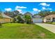 Well-kept single Gathering home boasts a manicured lawn and mature landscaping at 8045 Waterbury Way, Mount Dora, FL 32757