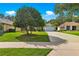 Single Gathering home with a long driveway and mature landscaping at 8045 Waterbury Way, Mount Dora, FL 32757