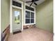 Welcoming front porch with decorative stone accents and stylish tile flooring at 8045 Waterbury Way, Mount Dora, FL 32757