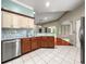 Beautiful kitchen featuring stainless steel appliances, chevron backsplash and stylish cabinets at 8045 Waterbury Way, Mount Dora, FL 32757