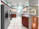 Well-equipped kitchen with stainless steel appliances, granite countertops, and chevron backsplash at 8045 Waterbury Way, Mount Dora, FL 32757